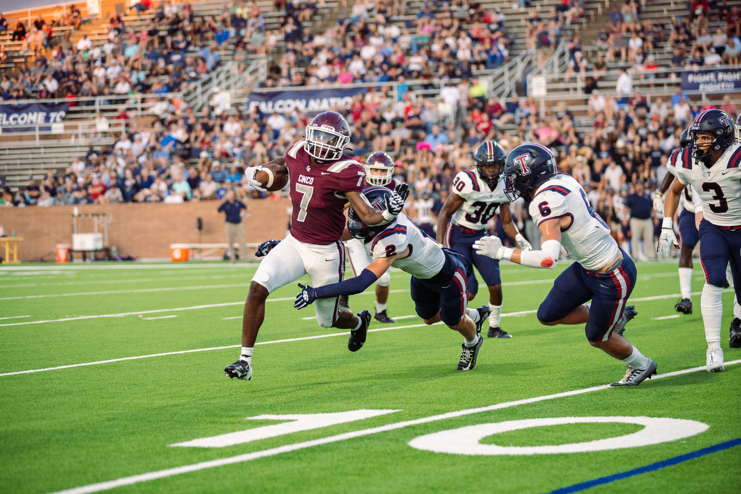 Cinco Ranch’s Sam McKnight breaks a tackle during Friday’s game between Cinco Ranch and Tompkins at Rhodes Stadium.